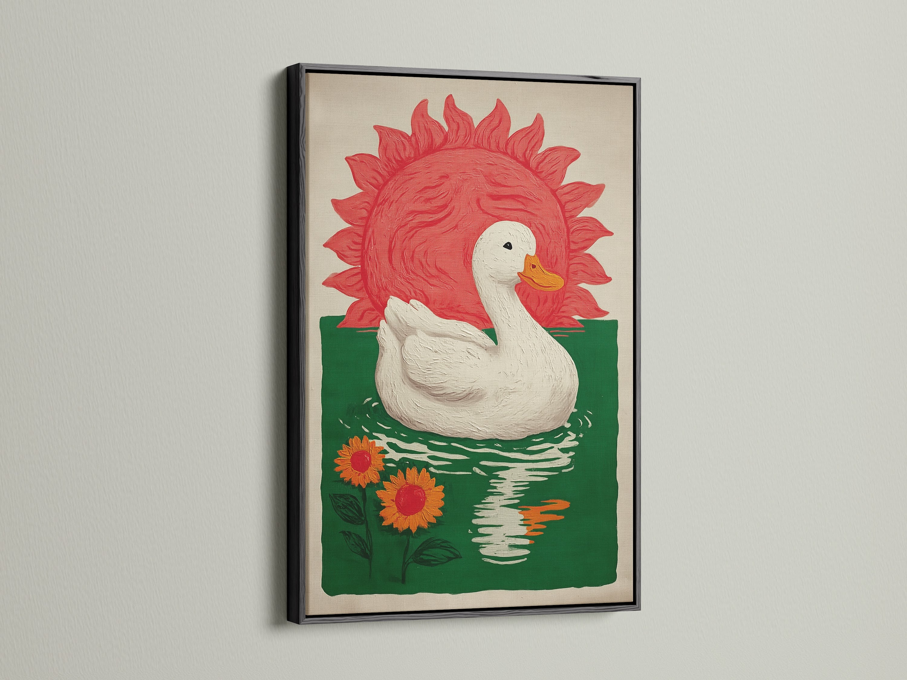 Bohemian Style Wall Art in a black frame. The art features a white duck floating on green water with orange sunflowers. A red sun is in the background. This bohemian decor would be great for a dining area. Consider this pond print for farmhouse rustic or eclectic styles.