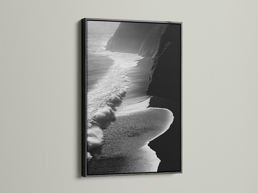 A striking black and white ocean waves artwork is showcased. It is framed in classic black. This piece adds a touch of modern elegance to any space. The aerial beach photography captures the ocean's beauty. The black frame provides a bold contrast. It is perfect for contemporary and minimalist styles. Elevate your living room or bedroom decor with this artwork.