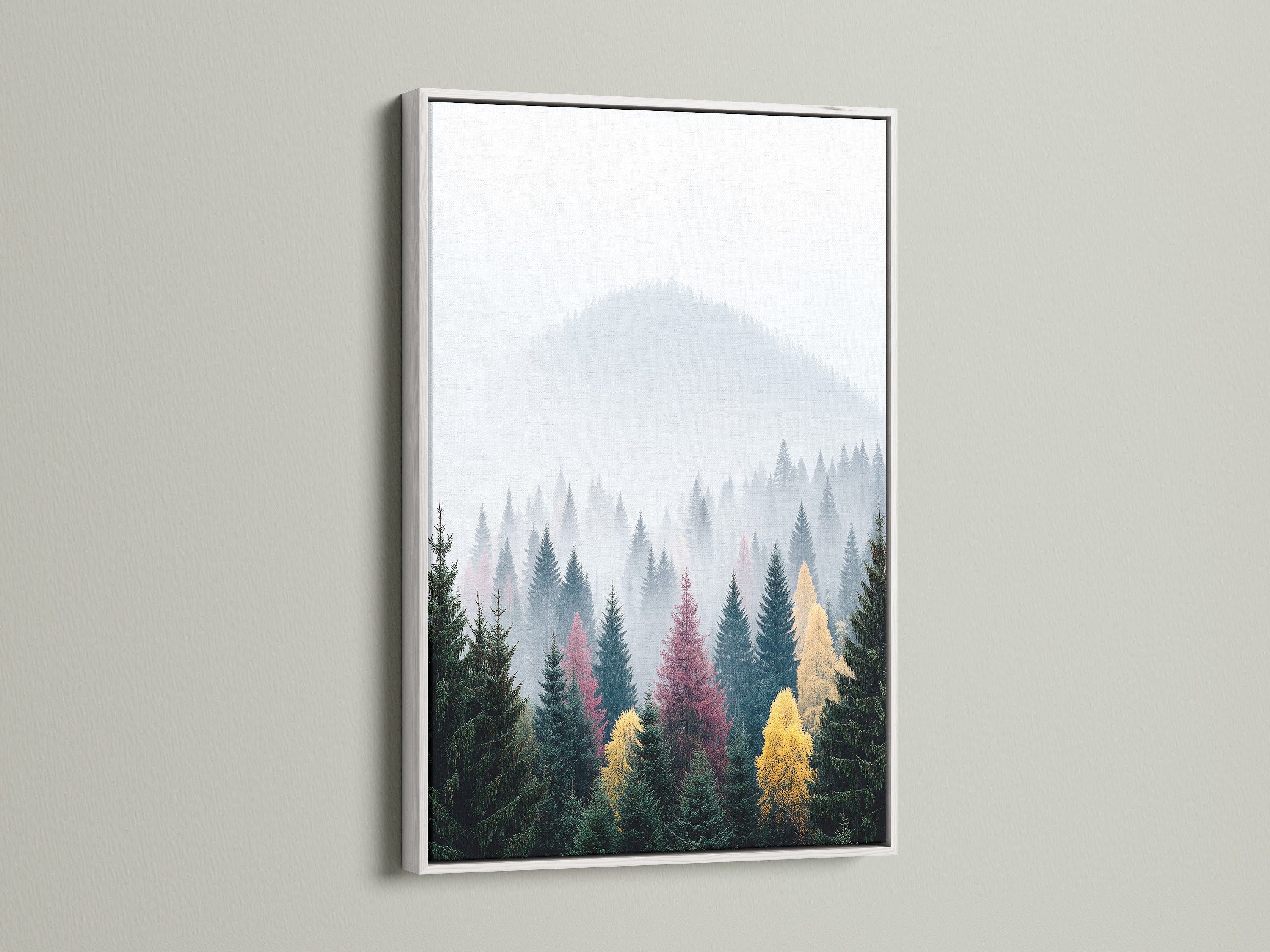 This is a modern mountain forest canvas print in a white frame. It is a stunning piece of landscape wall art. The misty mountains and evergreen trees create a calming effect. Ideal as bedroom art or office decor. A beautiful photography print.