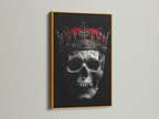 A regal skull king canvas print with a gold frame is displayed. This gothic decor brings a dark academia flair to your home. The macabre art piece is perfect for living rooms and bedrooms. This skull artwork is ideal for those who love spooky decor and gothic home accents. Elevate your space with this metal art.