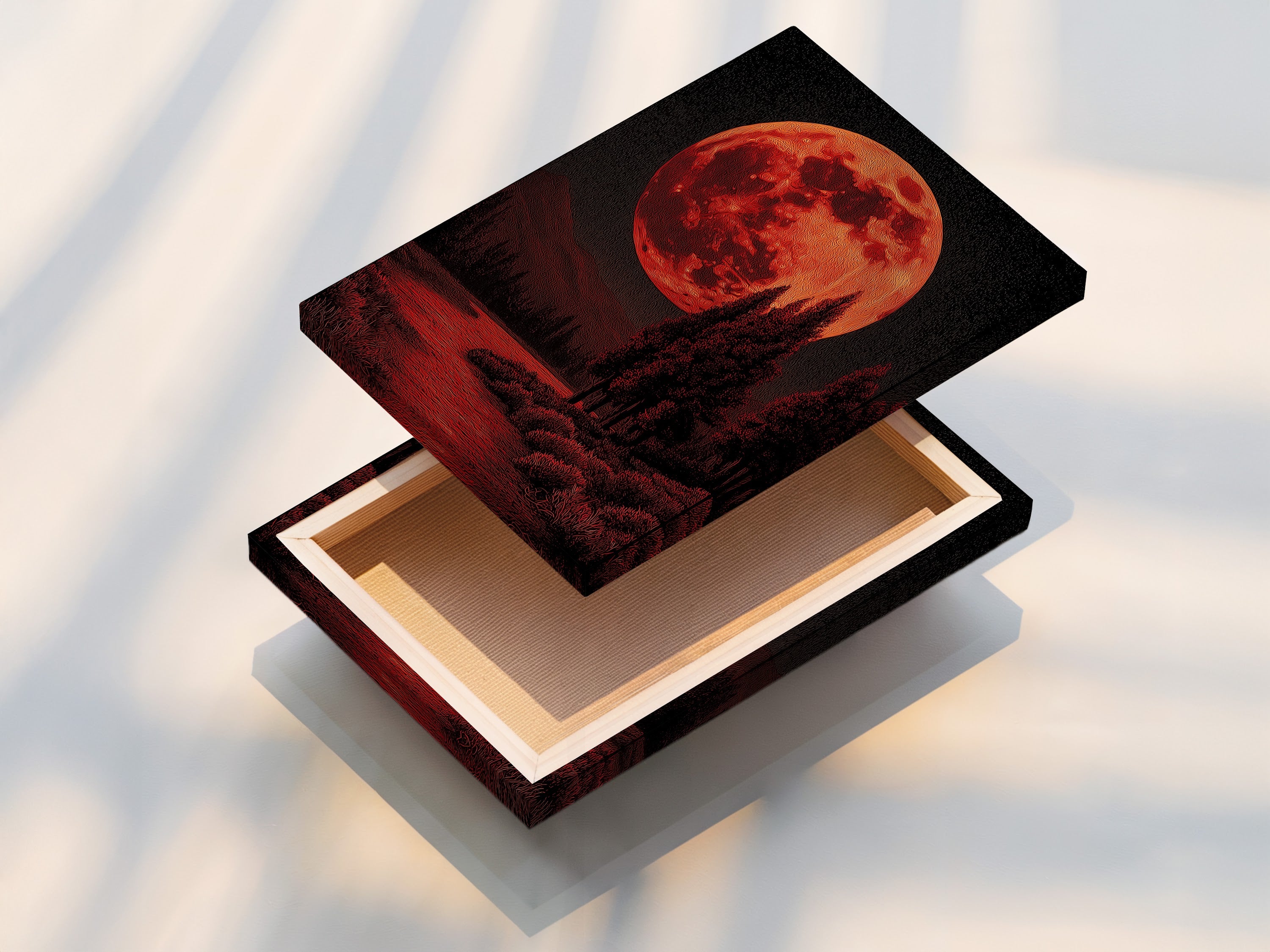 A stretched canvas print displays the red moon landscape artwork. The gothic wall art is ready to hang. The stretched canvas provides a professional and polished look for your celestial decor. Buy it now!