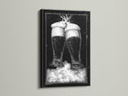Black frame artwork. The art features two beer glasses in black and white tones. This piece is mounted on a clean white wall. The frame is a sleek black color. Discover framed artwork options to enhance your space. Explore our selection today for the perfect piece.
