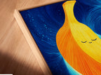 A close-up angled view showcases a Banana Family Canvas artwork print in a floating frame. This cute artwork is perfect for kids room decor. The abstract print adds a playful touch. It is a modern art print.