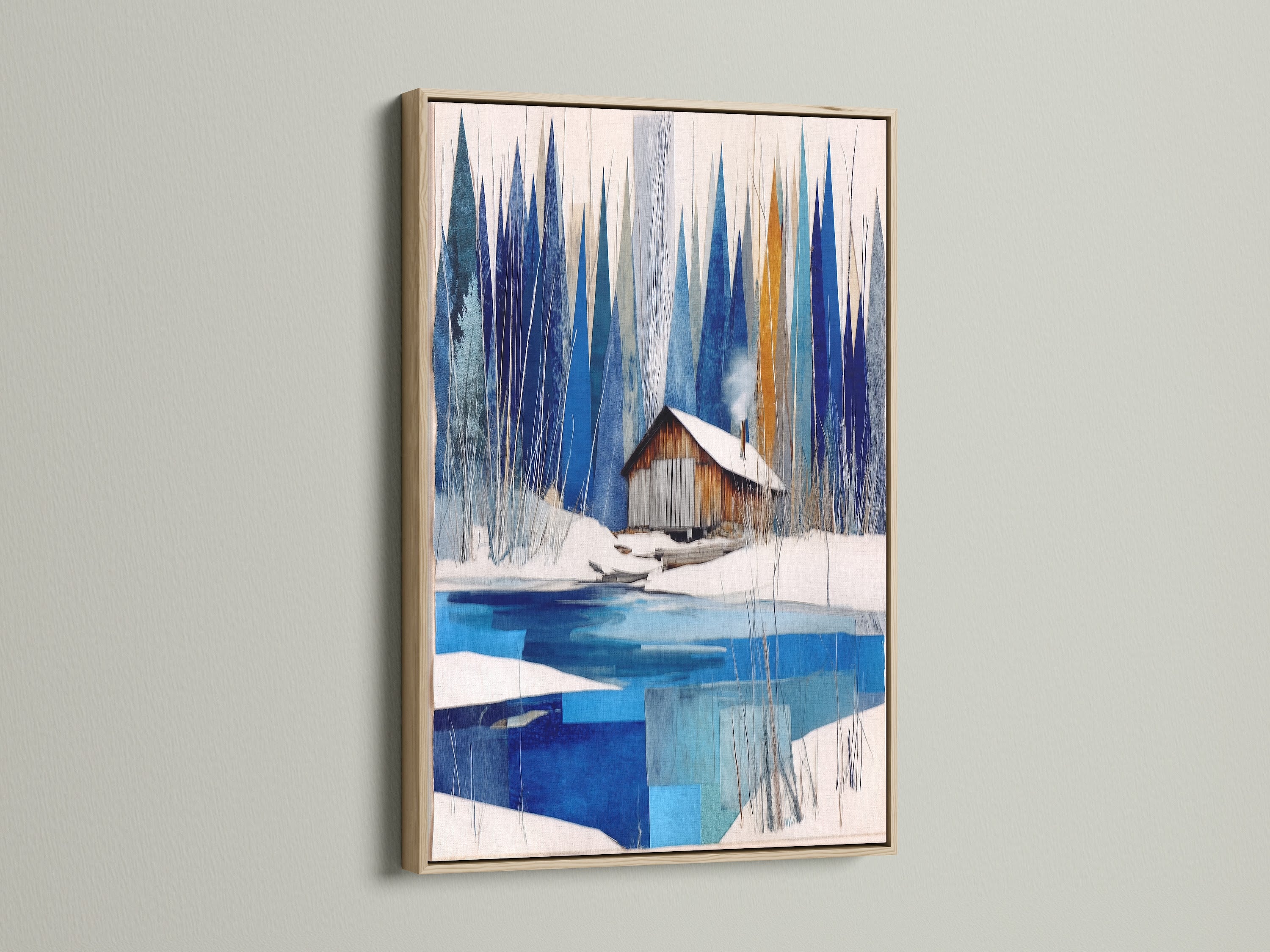 Winter Cabin Canvas Artwork with an oak frame. A serene snowy lake is depicted in this wall art. This piece is perfect for chalet decor. The oak frame adds a rustic touch to the blue and white abstract winter art. A modern wall art choice for nature print lovers and lake house decor.