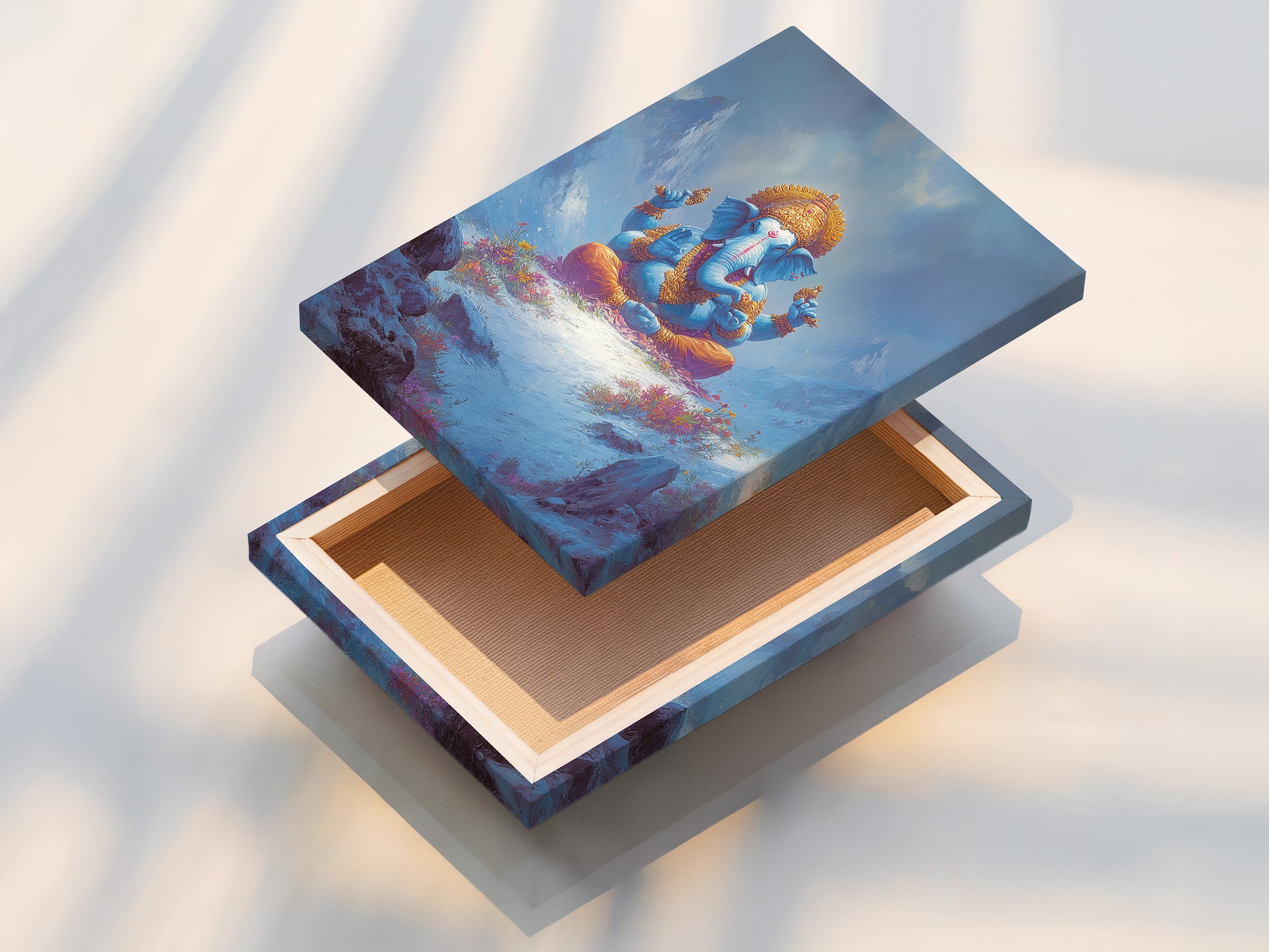 A stretched canvas print featuring Ganesha. This Hindu God artwork is ready to hang. The canvas brings spiritual peace to any room. Perfect for meditation rooms and yoga studios. The blue and gold colors enhance healing centers.