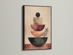 An abstract stacking canvas print is presented in a black frame. This modern artwork features terracotta geometric shapes and neutral tones. It's ideal for a minimalist or contemporary space. The print enhances office wall decor and home interiors.