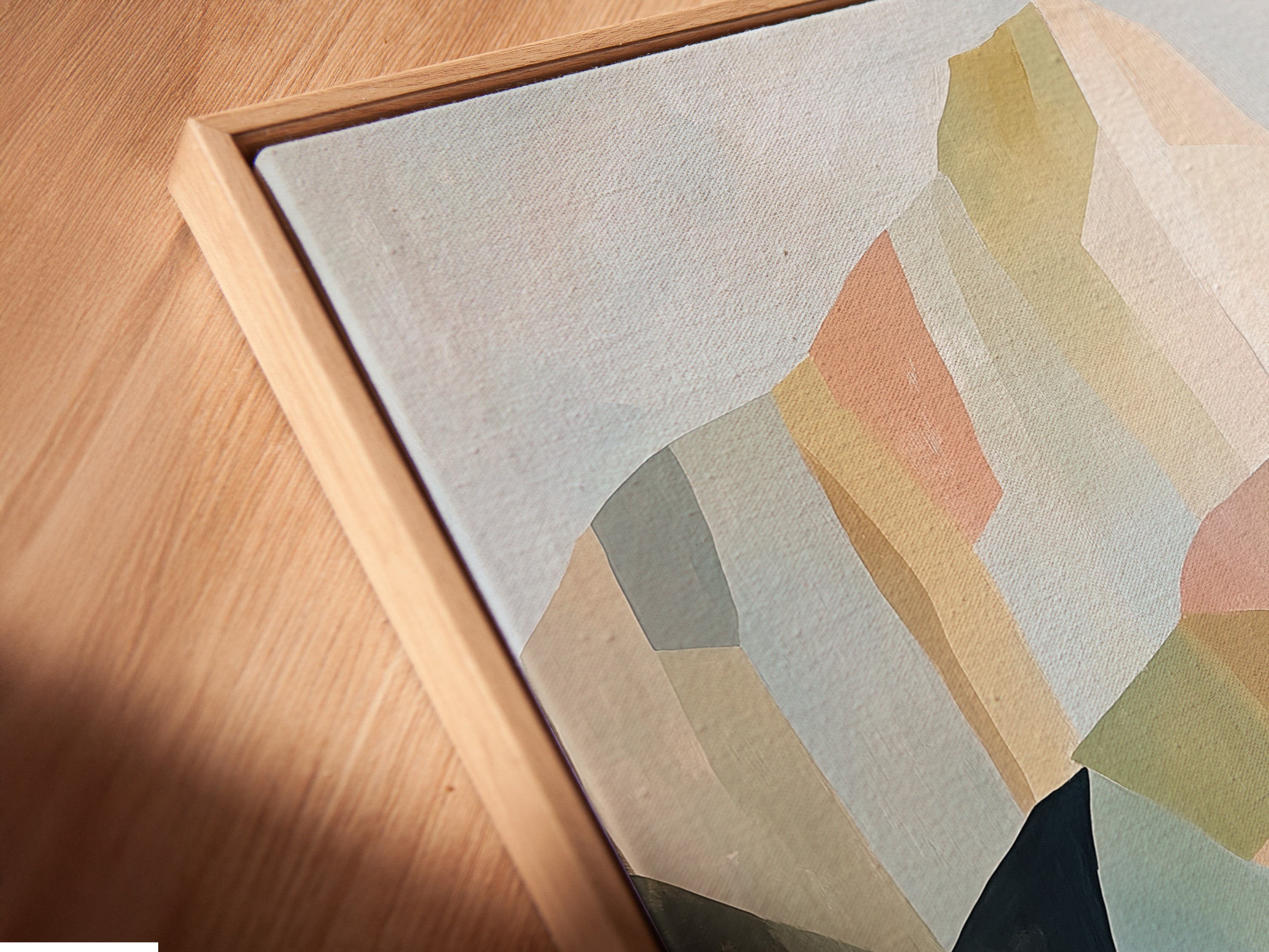 Angled close up of a canvas print featuring abstract mountain artwork in a floating frame. The contemporary wall art complements minimalist and modern aesthetics. Elevate your space today.