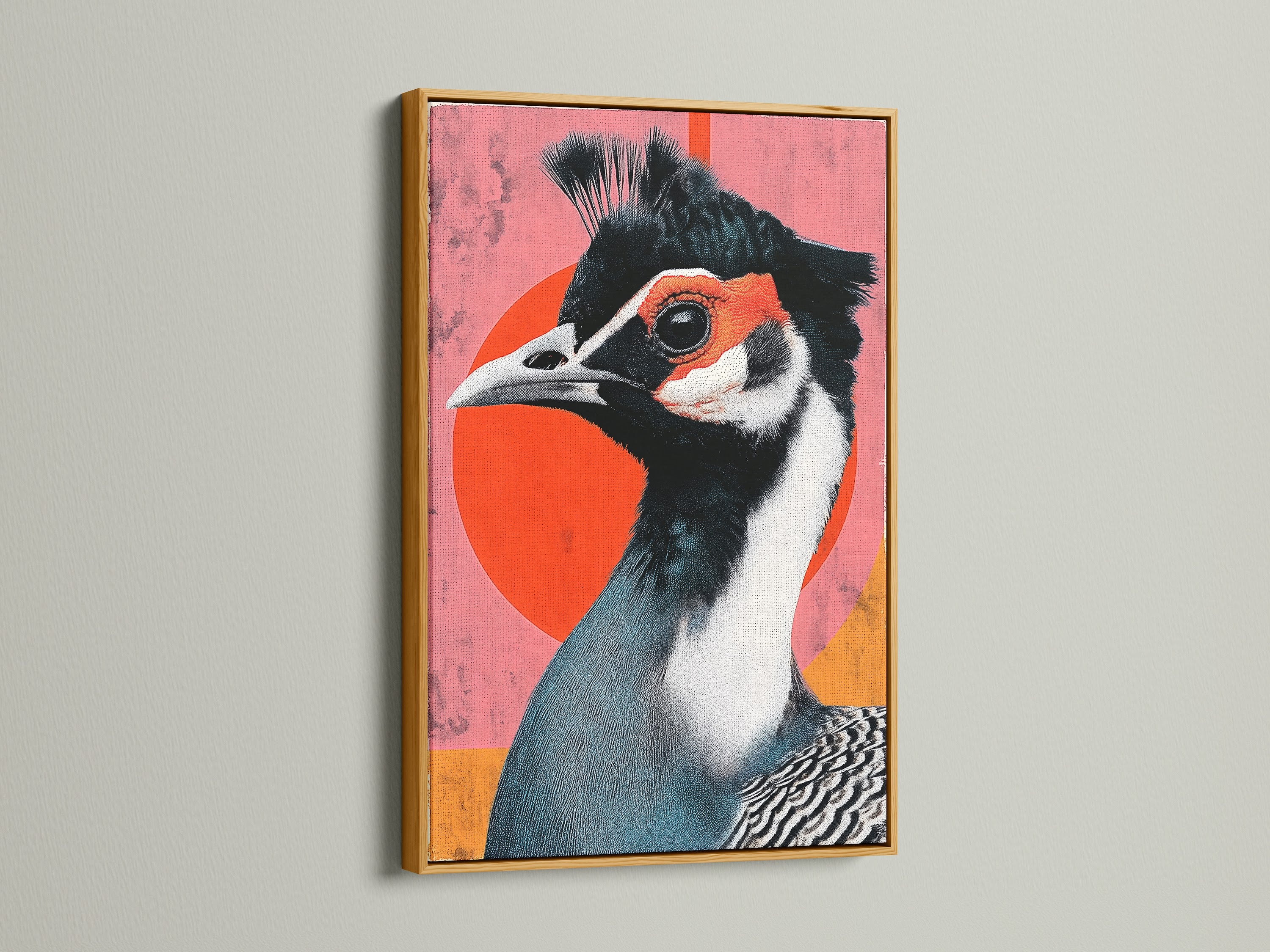 Exotic Bird canvas print in a gold frame. The artwork showcases a bird with teal and white feathers against a pink backdrop. A red circle is behind the bird. This vibrant art print is ideal for coffee shops studios and creative spaces. Shop Now.