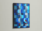 View this abstract art piece with a sleek black frame. The dark frame accentuates the blue shades of the modern artwork. A black frame adds a touch of sophistication. Perfect for modern art. Explore our collection of geometric wall art.