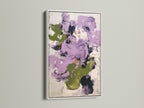 Abstract floral artwork in purple and green tones set in a white frame. This contemporary print offers a clean and modern aesthetic. Ideal for enhancing bedroom wall decor. The artwork's vibrant colors and abstract style create a focal point in any space.