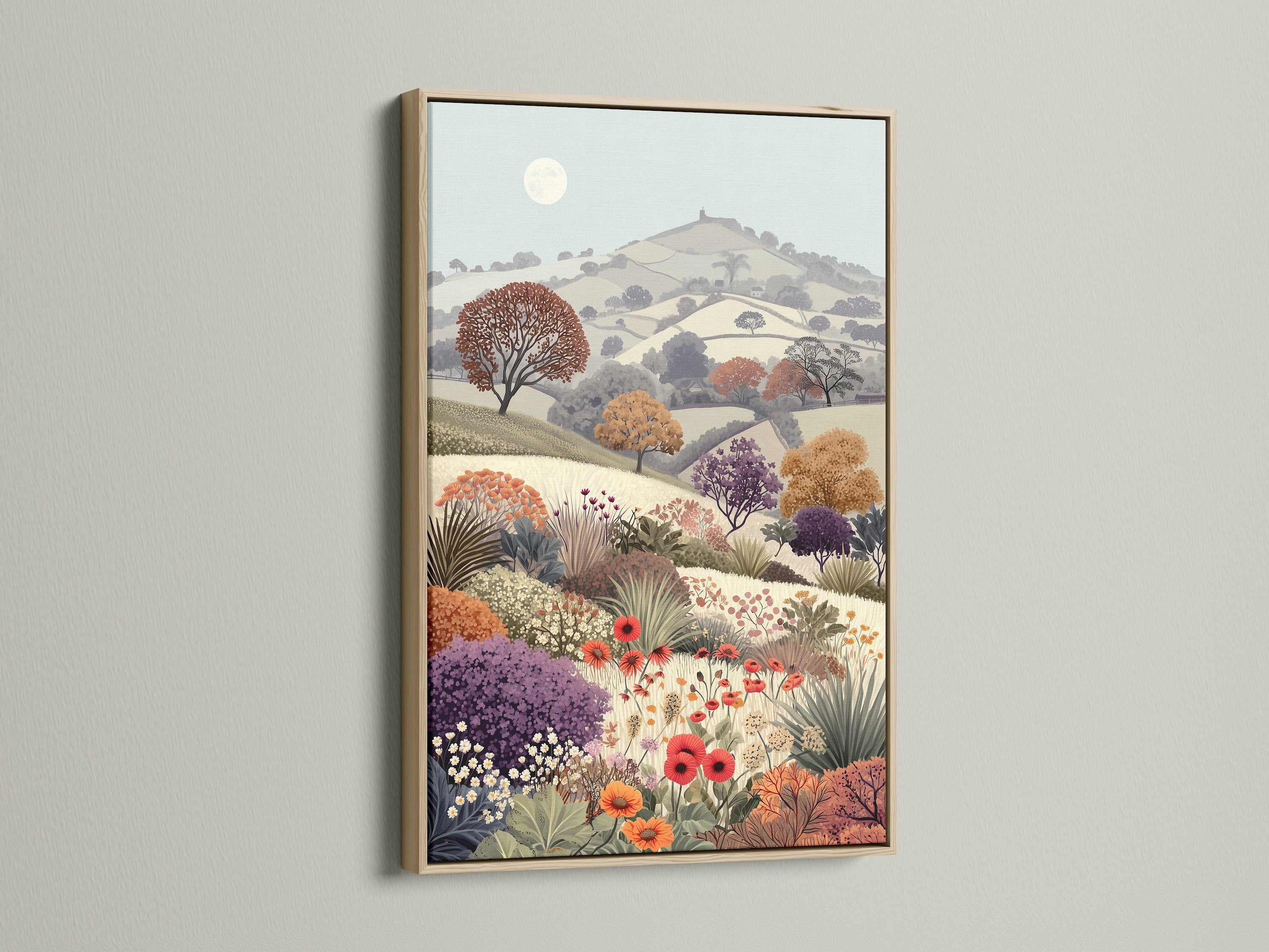 A framed Floral Meadow artwork in an oak frame. The vintage landscape features a flower field and countryside scenery. This botanical artwork brings a touch of rural charm. The serene pastel colors and wildflower print add a cottagecore feel to any room. Perfect for study wall decor and nature lovers