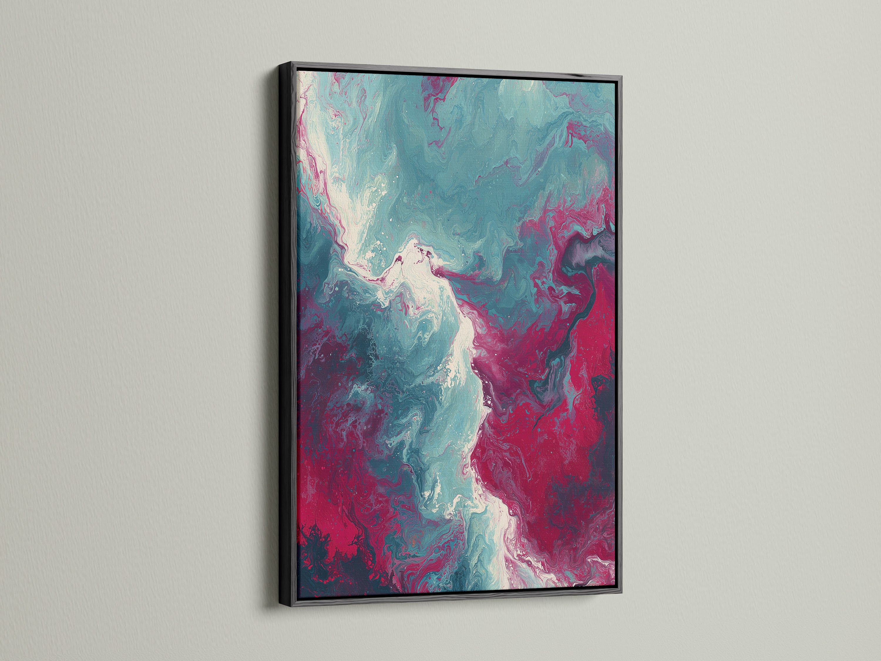 This photo features an abstract fluid art print with a sleek black frame. The artwork showcases a beautiful blend of teal and pink hues creating a modern marble swirl. The black frame provides a bold contrast. It makes it a striking addition to any contemporary decor setting.