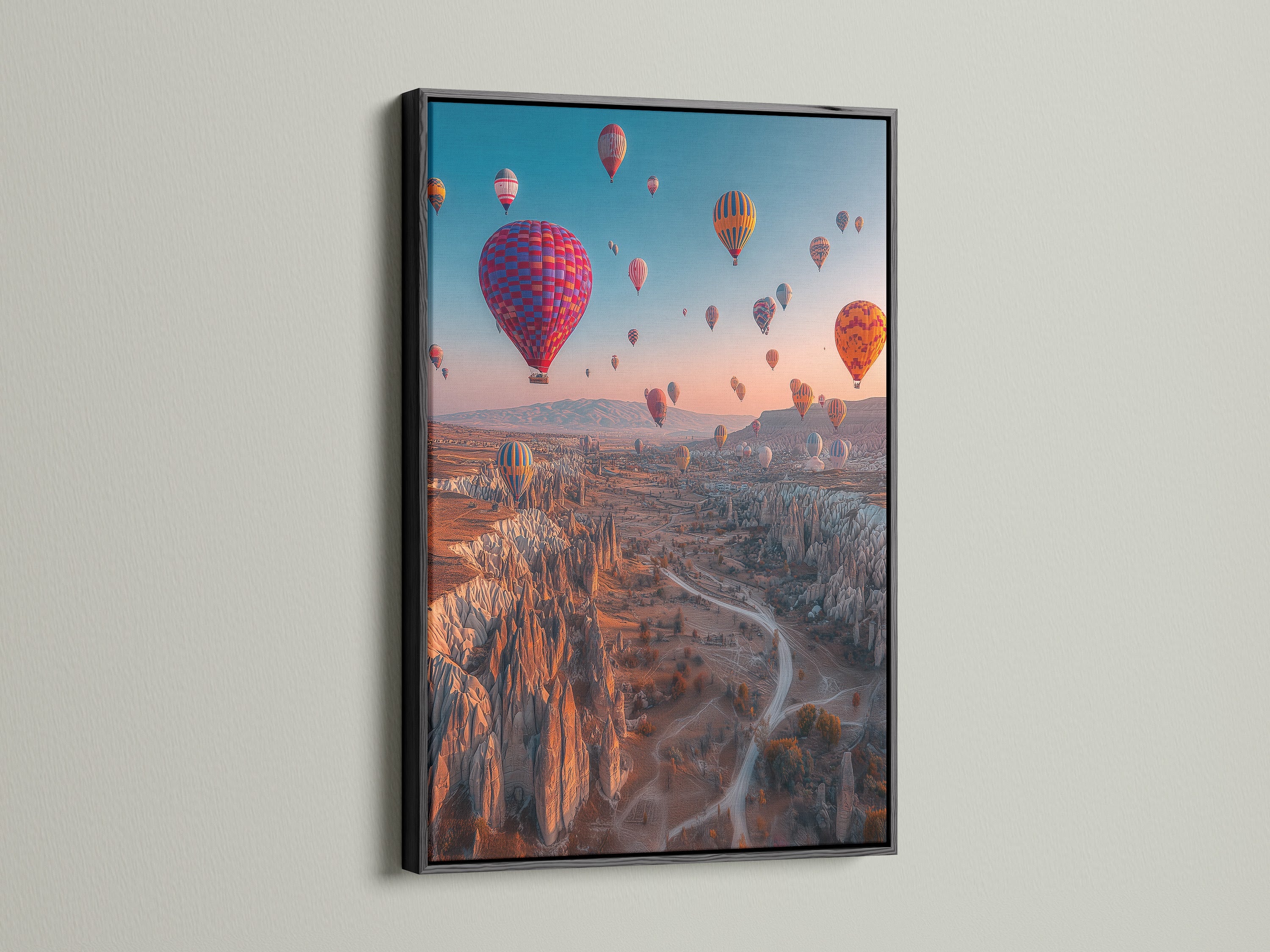 The black frame contrasts beautifully with the hot air balloon artwork. This landscape canvas adds a sophisticated touch to any space. Ideal as travel wall art. It is perfect for modern interiors and eclectic styles.