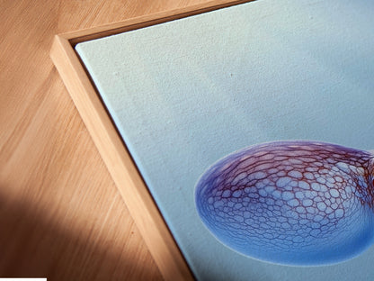 A close-up angle reveals the texture of this canvas print. The floating frame adds depth to the octopus artwork. Teal blue hues enhance the marine animal details. Perfect for adding a touch of coastal style to your home. Explore the details of this ocean print.