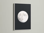 Full Moon lunar phase artwork with a white frame. This celestial art brings astronomy decor to any bedroom. It is a moon phase art showcase. It enhances space themed art in modern settings. It is a great astrology gift. This is a beautiful night sky print. Ideal as full moon artwork and a celestial print.