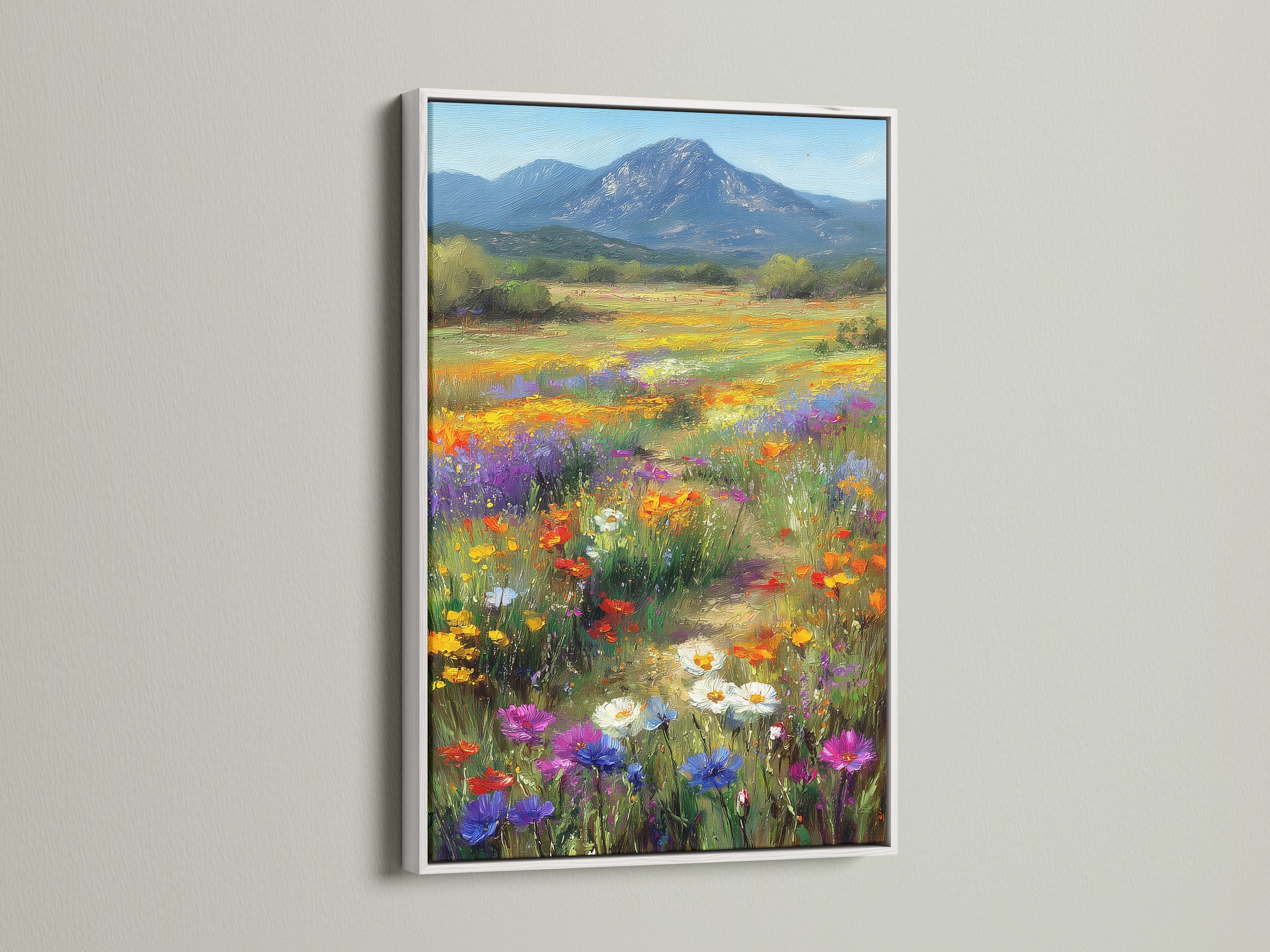 Botanical wildflower meadow artwork with a white frame. This colorful wall art brings nature indoors. The mountain landscape adds depth and serenity. Ideal bedroom wall decor for a fresh look.