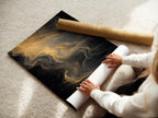 A woman is carefully rolling a fine art poster paper. The paper features artwork ready for framing or display. High-quality fine art paper ensures vibrant colors. Preserve the beauty of your art with premium materials.