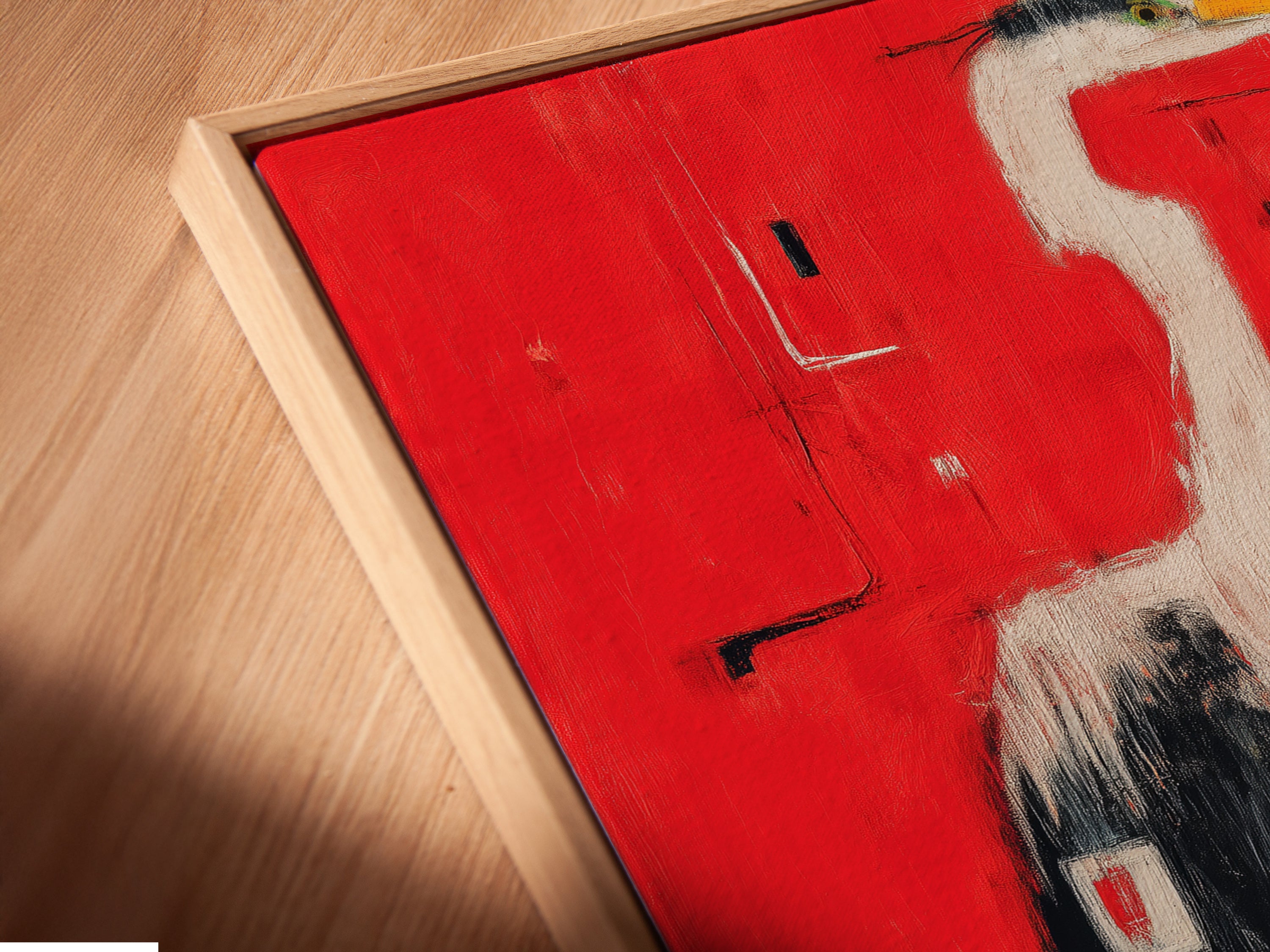 Close-up angled view of a Heron Art canvas print in a floating frame. This red abstract wall art features a modern bird artwork. The floating frame gives the artwork a gallery-style appearance.