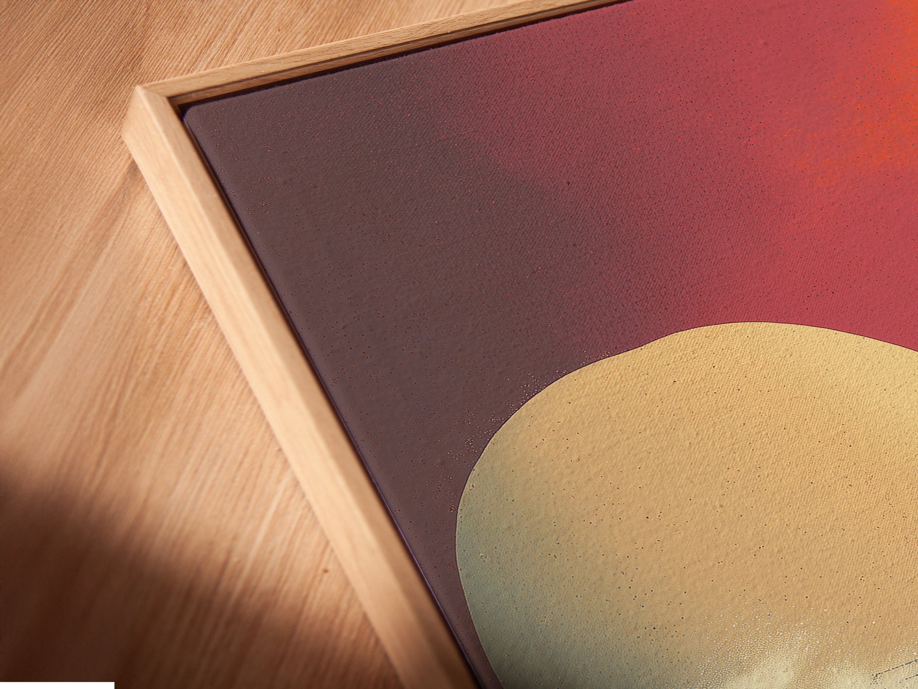 A close-up angle reveals the details of a canvas print in a floating frame. The modern coastal artwork features a sunset pier scene. The house on a pier stands out against the vibrant orange and pink sky. Perfect for those seeking modern art prints or beach house art. Elevate your space with this ocean canvas.