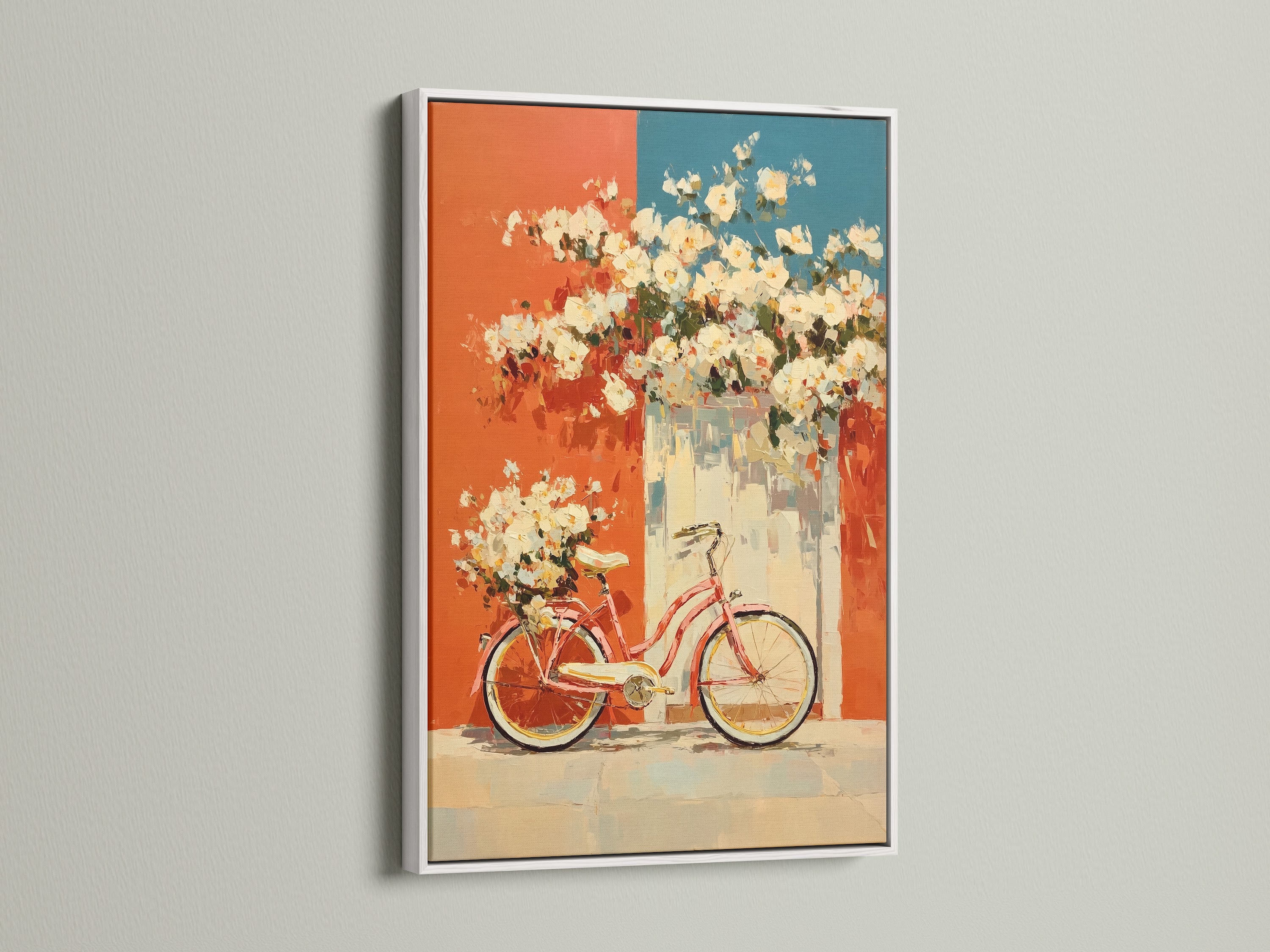 Vintage bicycle artwork displayed in a white frame. The artwork features floral accents in coral and teal. This retro poster adds a touch of mid-century style to any kitchen or living room. The white frame offers a clean and modern look. It's perfect for adding a distinctive touch to your home decor.