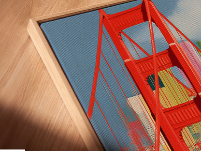 A close-up angled view reveals a canvas print of the Golden Gate Bridge in a floating frame. This San Francisco wall art is a modern cityscape poster. It is perfect for adding a touch of California decor to your office or living space. The vibrant colors enhance any room.