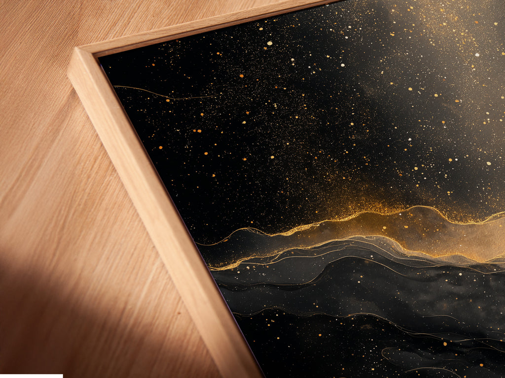 A close up of a canvas print in a floating frame. The art is abstract black and gold. The floating frame gives the art a modern look. It creates a shadow effect. The canvas print adds texture to the artwork. This is a stylish piece for any home.