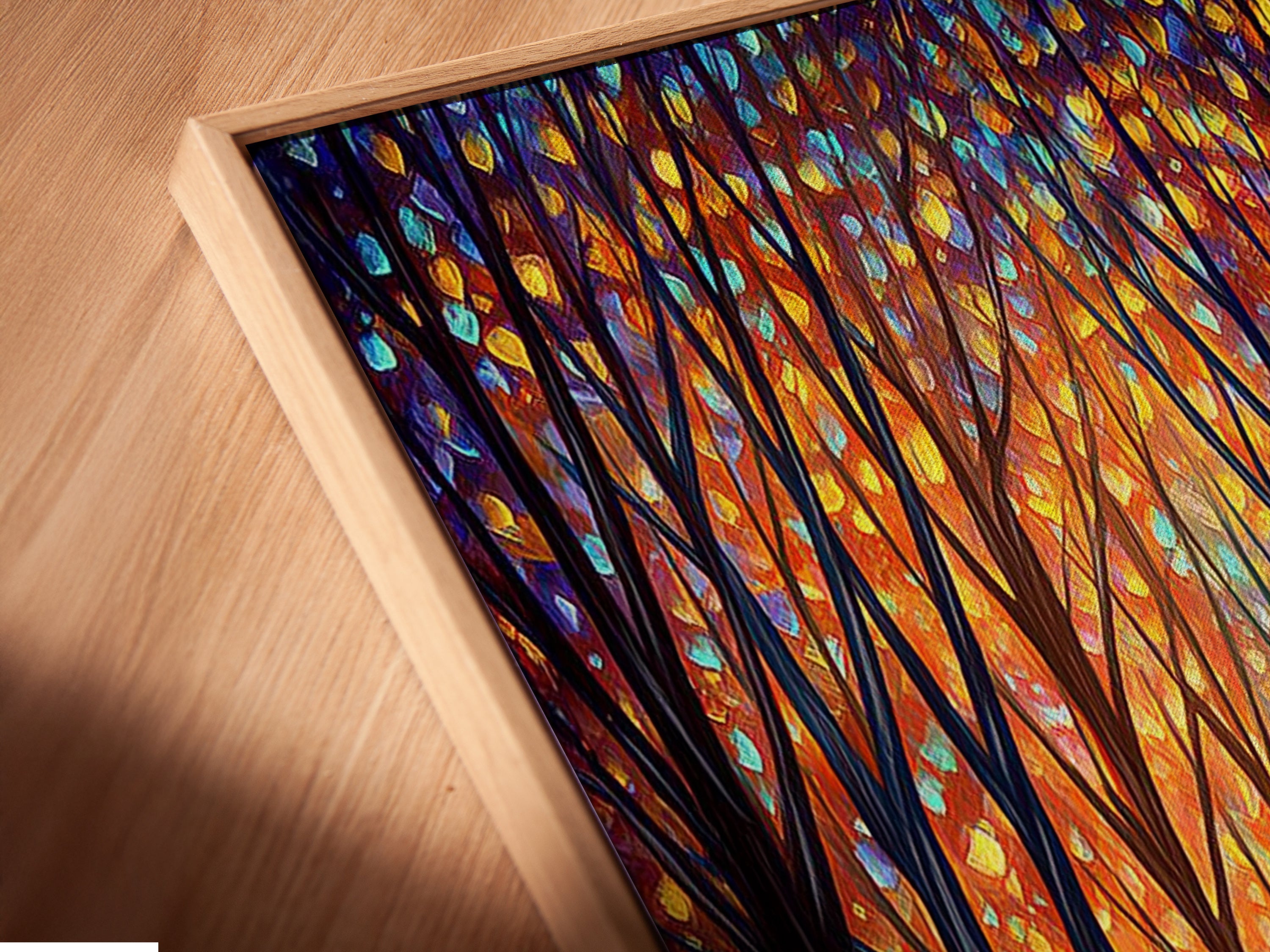 A close-up angled view showcases a canvas print in a floating frame. This modern nature artwork features abstract trees. The colorful forest scene is perfect for contemporary wall decor enhancing any space.