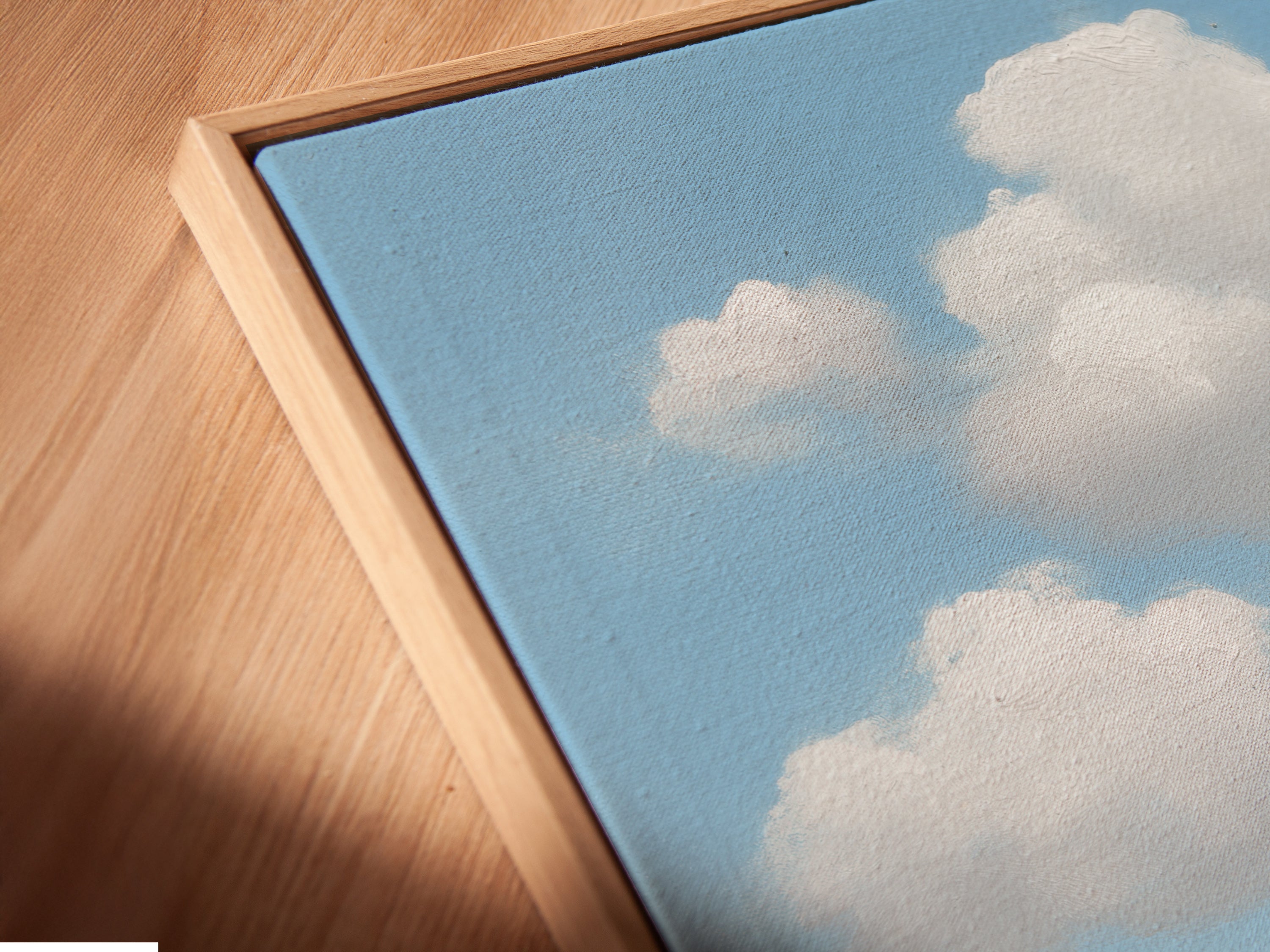 Angled close up of a canvas print in a floating frame. Coastal art that is ready to hang. The floating frame gives a modern look. Perfect for living rooms or bedrooms.