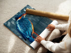 A woman is carefully rolling a fine art poster paper. The kingfisher artwork is ready for framing. This wildlife print is a perfect decor choice. The teal wall art will be shipped to its new home