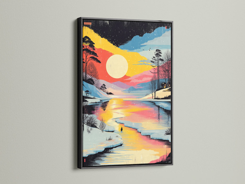 Winter Sunset Canvas Print in a black frame. This artwork captures a colorful lake landscape. The snowy forest artwork offers a modern touch. It is perfect for those seeking upscale wall art.
