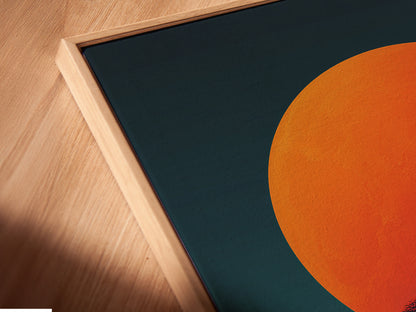 A close-up angled view reveals the canvas print in a floating frame. The floating frame gives the abstract sunset art depth. The modern geometric design becomes more pronounced. The coral orange colors create a captivating effect. This contemporary piece adds sophistication. Ideal for those seeking unique wall art. Enhance your interior with this stunning framed artwork.