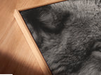 Close-up of a canvas print in a floating frame. The black and white wolf portrait exudes modern elegance. Perfect for creating a focal point in any room. See the fine details and quality craftsmanship of this animal artwork.