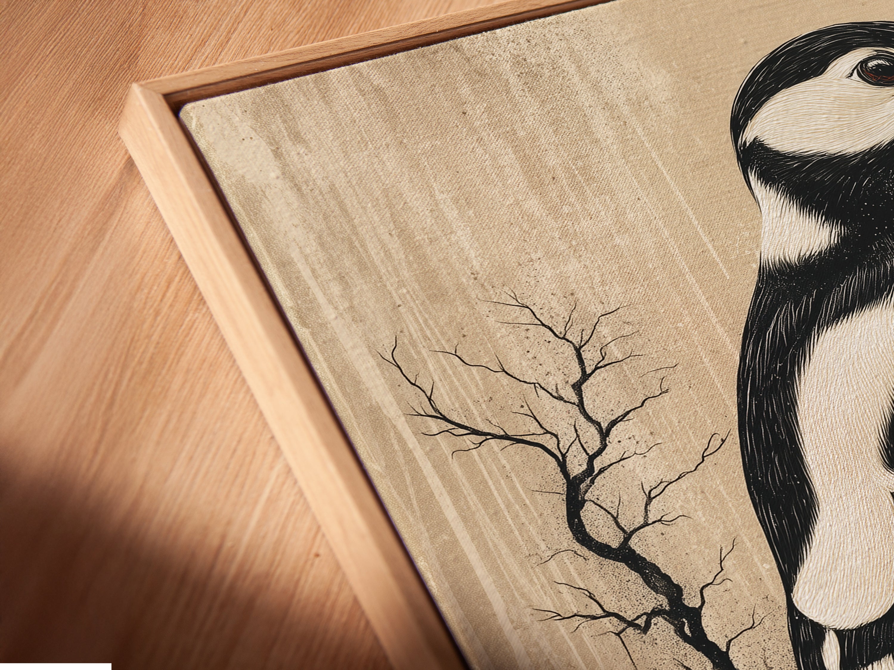 A close-up angled view of a canvas print in a floating frame. This woodpecker artwork brings rustic charm to any room. Vintage bird wall art ideal for a cozy atmosphere. Neutral tones make it perfect for study rooms. Ornithology art for bird and nature lovers. Enhance minimalist farmhouse and eclectic styles