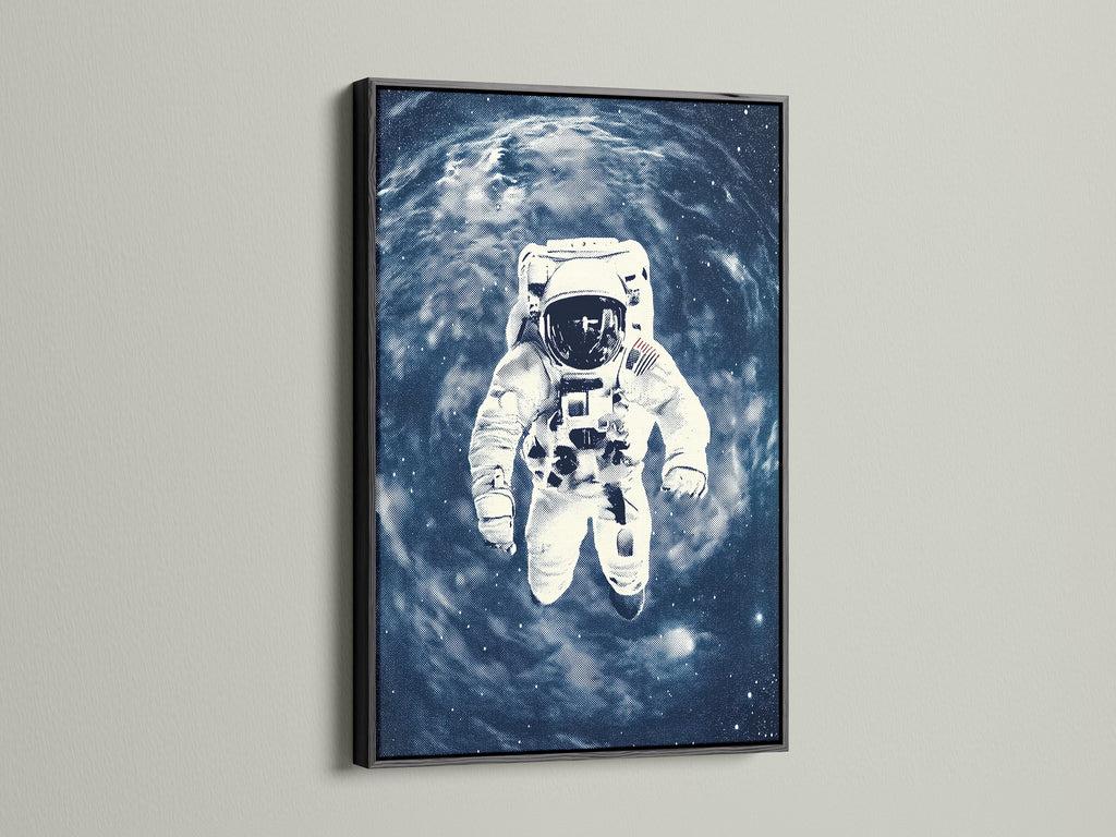 A striking black frame encases the astronaut space art print. The dark frame accentuates the vibrant blue galaxy wall art. It provides a bold statement piece for contemporary minimalist or industrial interiors. A space explorer canvas.