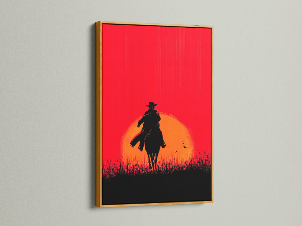 Cowboy Sunset Canvas Print with gold frame. The red orange silhouette of a horse rider adds a touch of western flair. This artwork is perfect for man caves offices or any space needing rustic wall decor. This is a stunning sunset wall art piece.