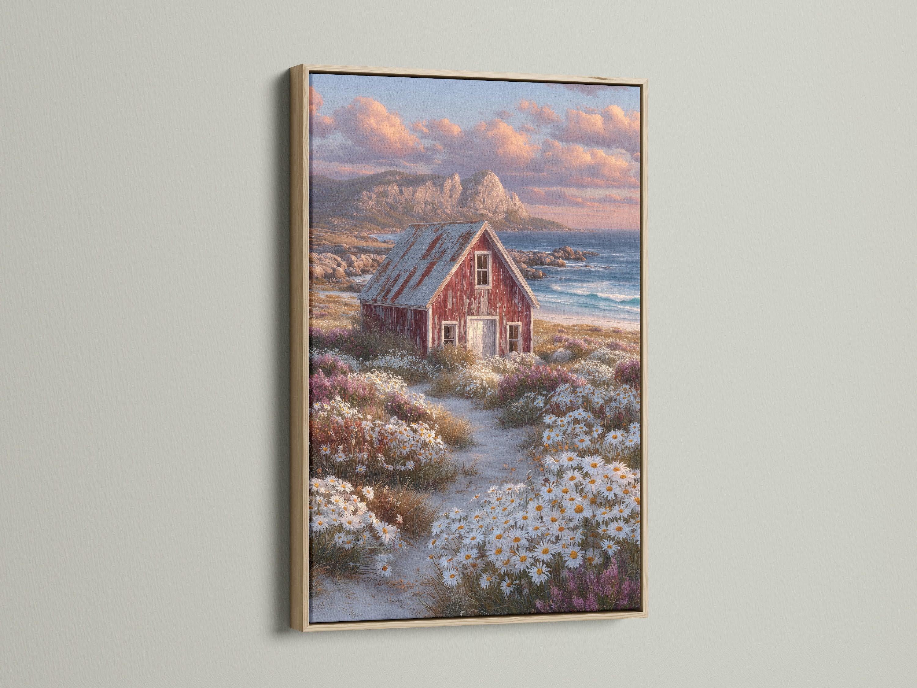Coastal cottage art featuring a rustic red barn and ocean view. It is showcased in a light oak frame. This seaside wall art enhances farmhouse decor. It brings a touch of country charm to any space.