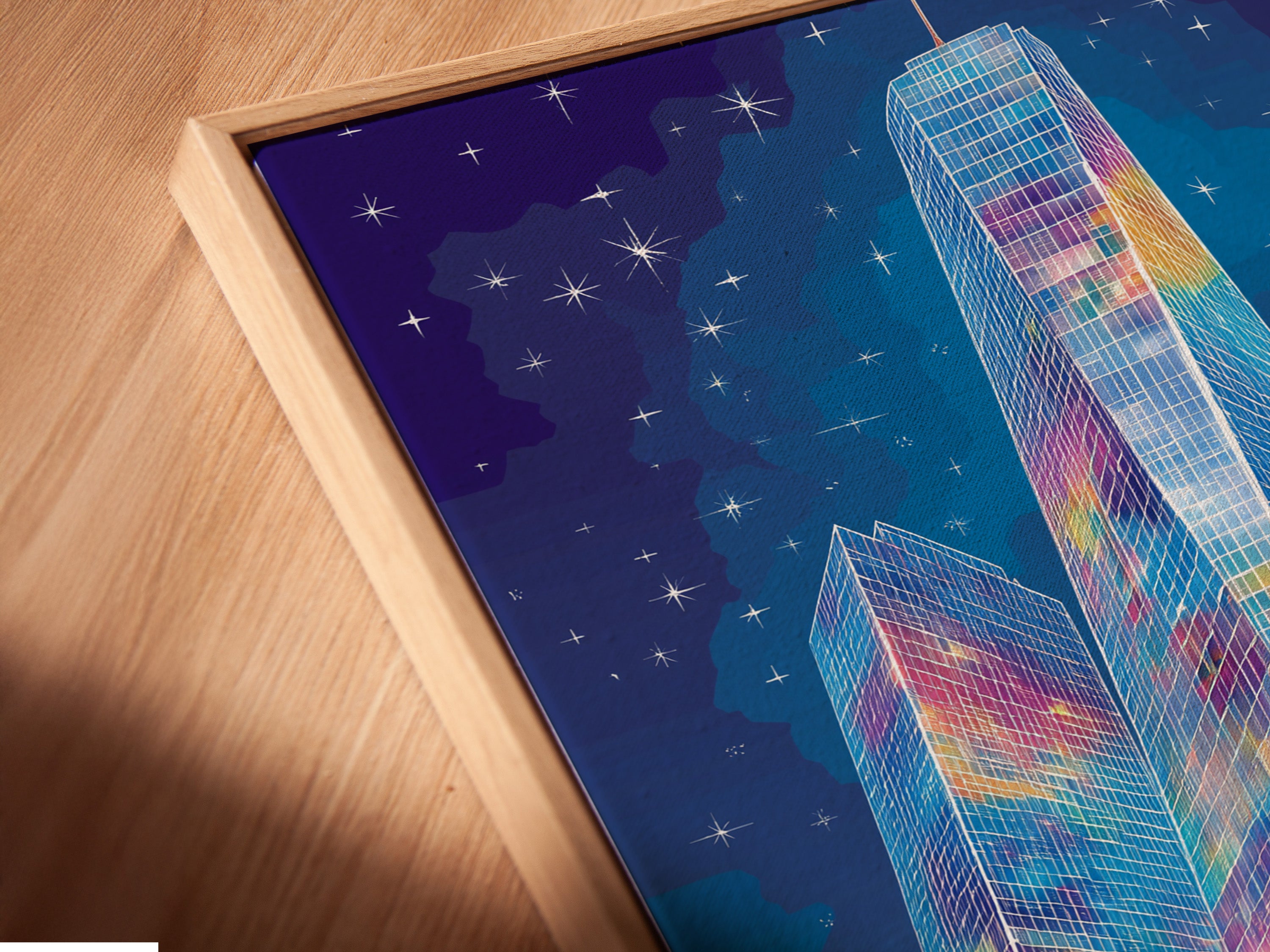 A close up angled view reveals a canvas print in a floating frame. The colorful city skyline artwork appears to float. This modern urban art adds depth and style to your walls. The floating frame enhances the contemporary art aesthetic.