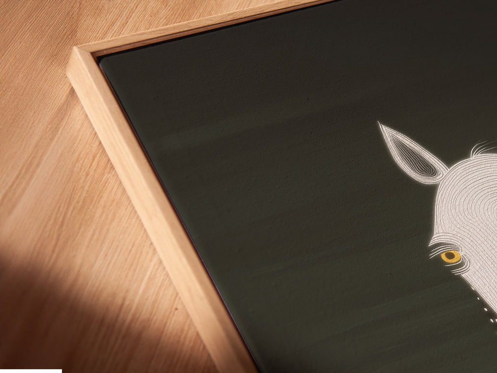 Angled close up of a horse portrait in a floating frame. The frame adds a touch of sophistication. This minimalist equestrian piece is perfect for a modern farmhouse. Enhance your home with this unique animal artwork.