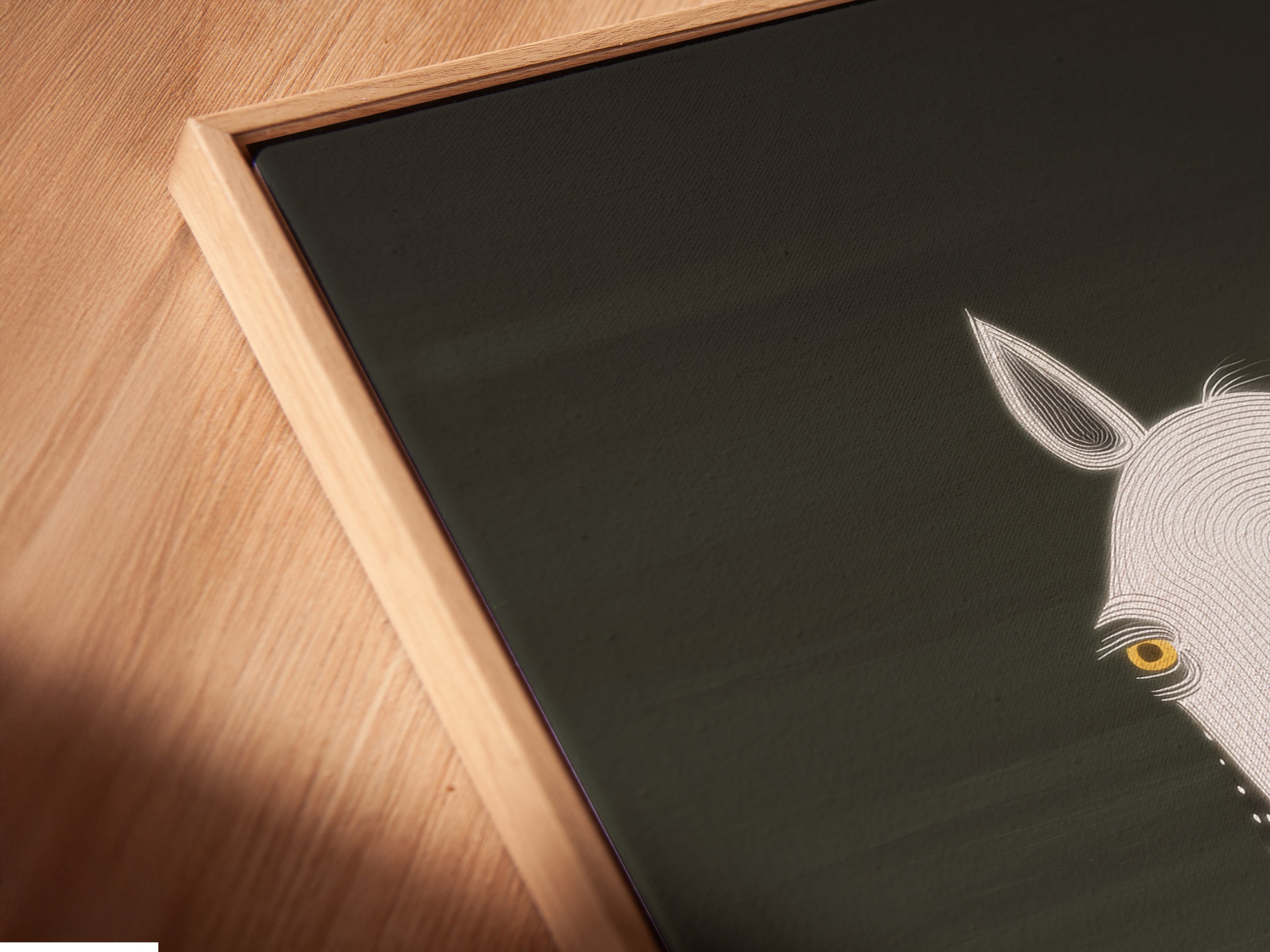 Angled close up of a horse portrait in a floating frame. The frame adds a touch of sophistication. This minimalist equestrian piece is perfect for a modern farmhouse. Enhance your home with this unique animal artwork.