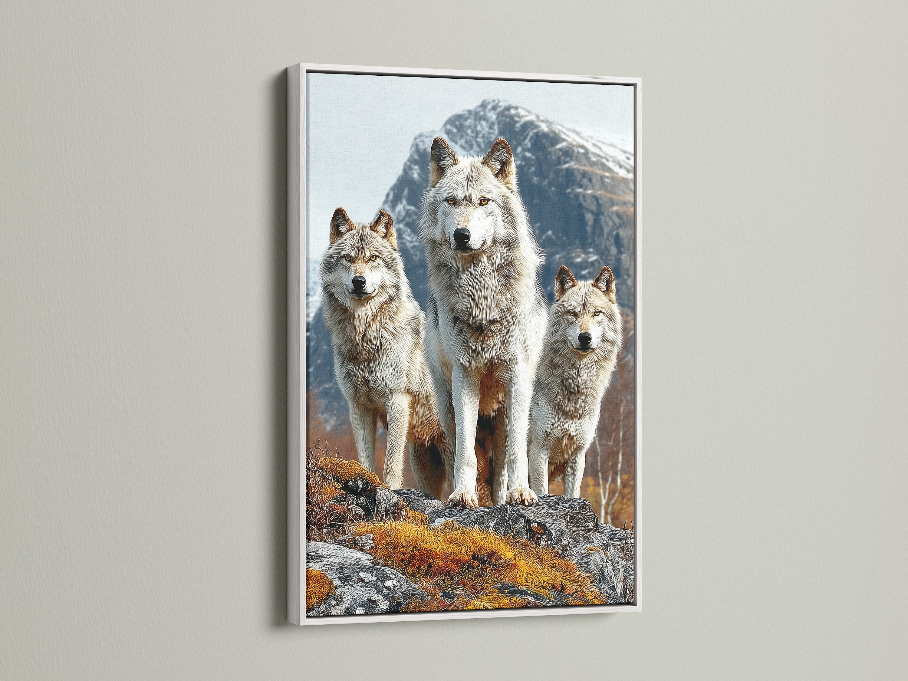 Showcasing a wolf pack canvas print in a white frame. The white frame enhances the wildlife animal artwork. It will brighten up any room. Perfect for creating a serene and natural atmosphere. Ideal for homeowners and renters seeking lodge-style wall art. Transform your living space with this nature print.