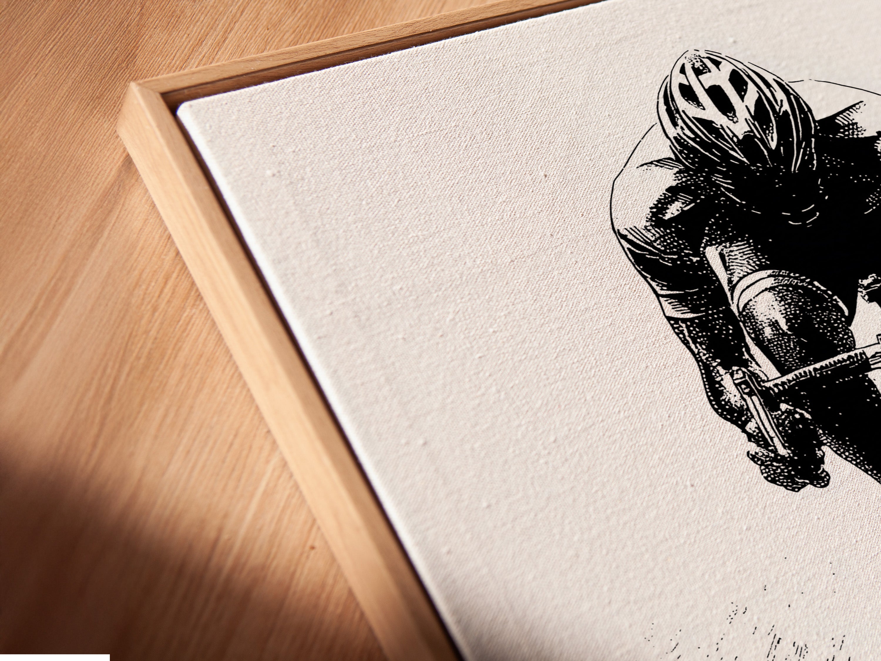 A close-up view of a cycling art canvas print. It is displayed in a floating frame. The floating frame gives the artwork a modern look. See how the artwork enhances the wall. The fine art poster paper ensures exceptional quality. Perfect for any sports fan.