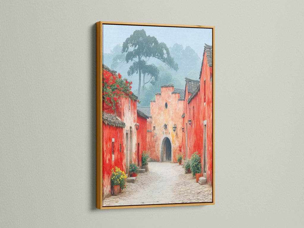 Village Street art with a gold frame. The gold frame enhances the vintage charm of this red and peach artwork. Add a touch of elegance to your entryway with this framed travel art. This artwork creates a unique ambiance.