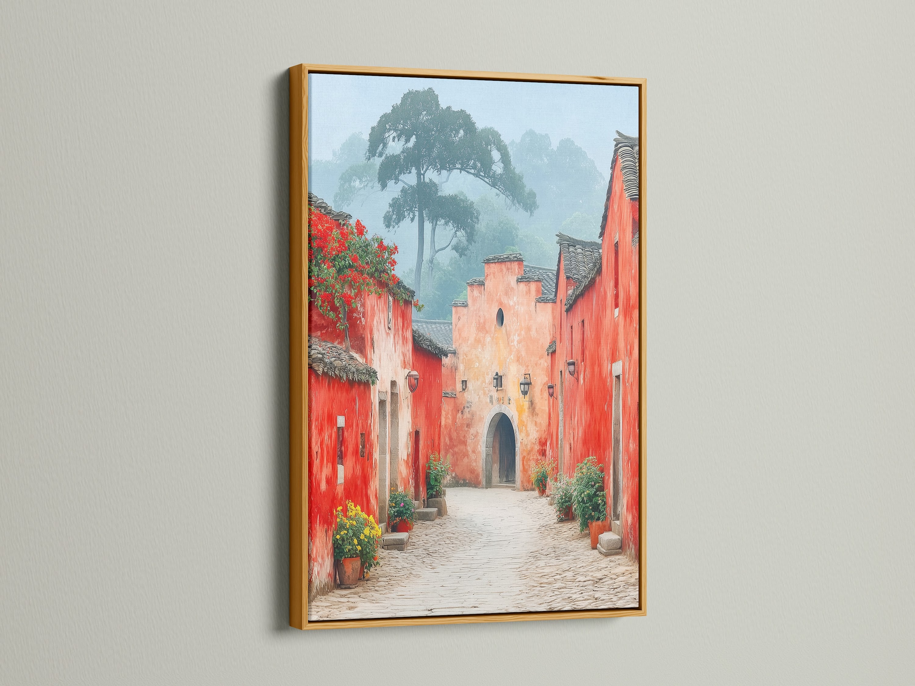 Village Street art with a gold frame. The gold frame enhances the vintage charm of this red and peach artwork. Add a touch of elegance to your entryway with this framed travel art. This artwork creates a unique ambiance.