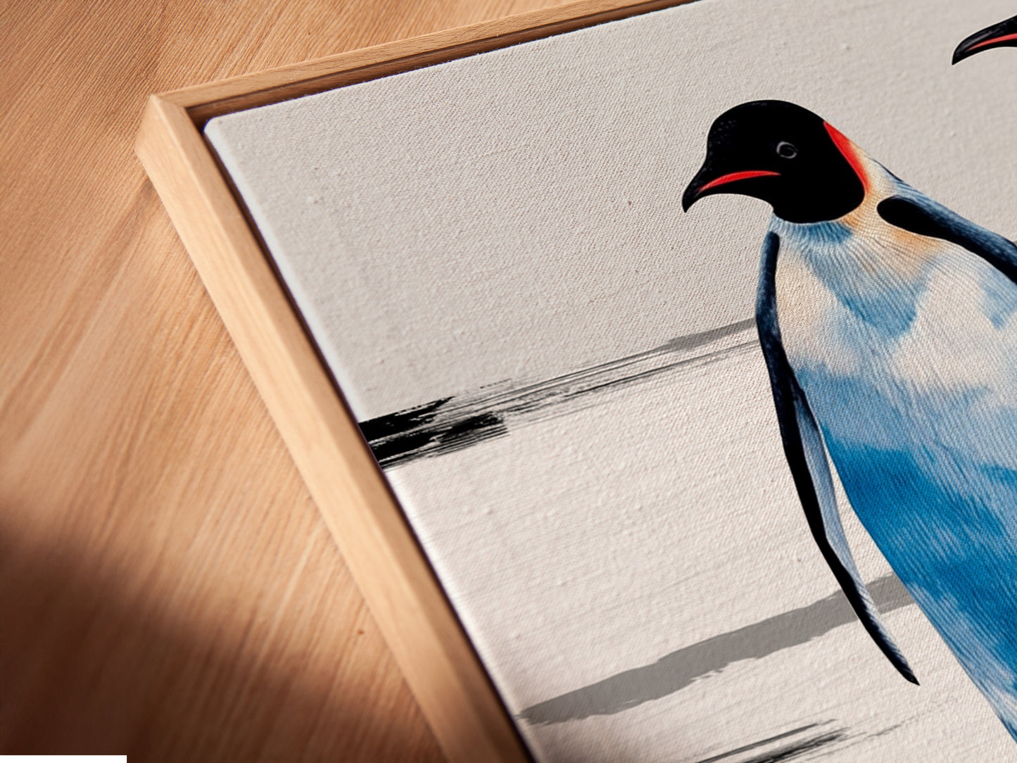 Close-up of a canvas print in a floating frame. The penguin family artwork is beautifully displayed. This coastal wall decor enhances nurseries and living rooms. A unique animal artwork for any home.