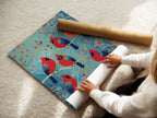 A woman is carefully rolling a fine art poster paper featuring the 'Cardinal Birds' artwork. This high-quality print captures the colorful birds. Ideal for bird watching art and wildlife art.