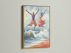 Joyful seascape wall art in a gold frame. The artwork presents a man and women jumping over a wave on the beach. The gold frame adds a touch of elegance. Find this ocean painting for your bedroom wall decor