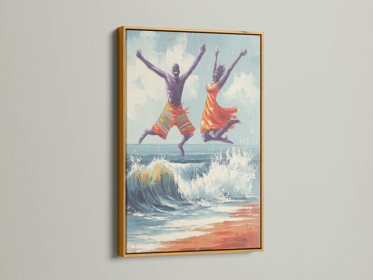 Joyful seascape wall art in a gold frame. The artwork presents a man and women jumping over a wave on the beach. The gold frame adds a touch of elegance. Find this ocean painting for your bedroom wall decor