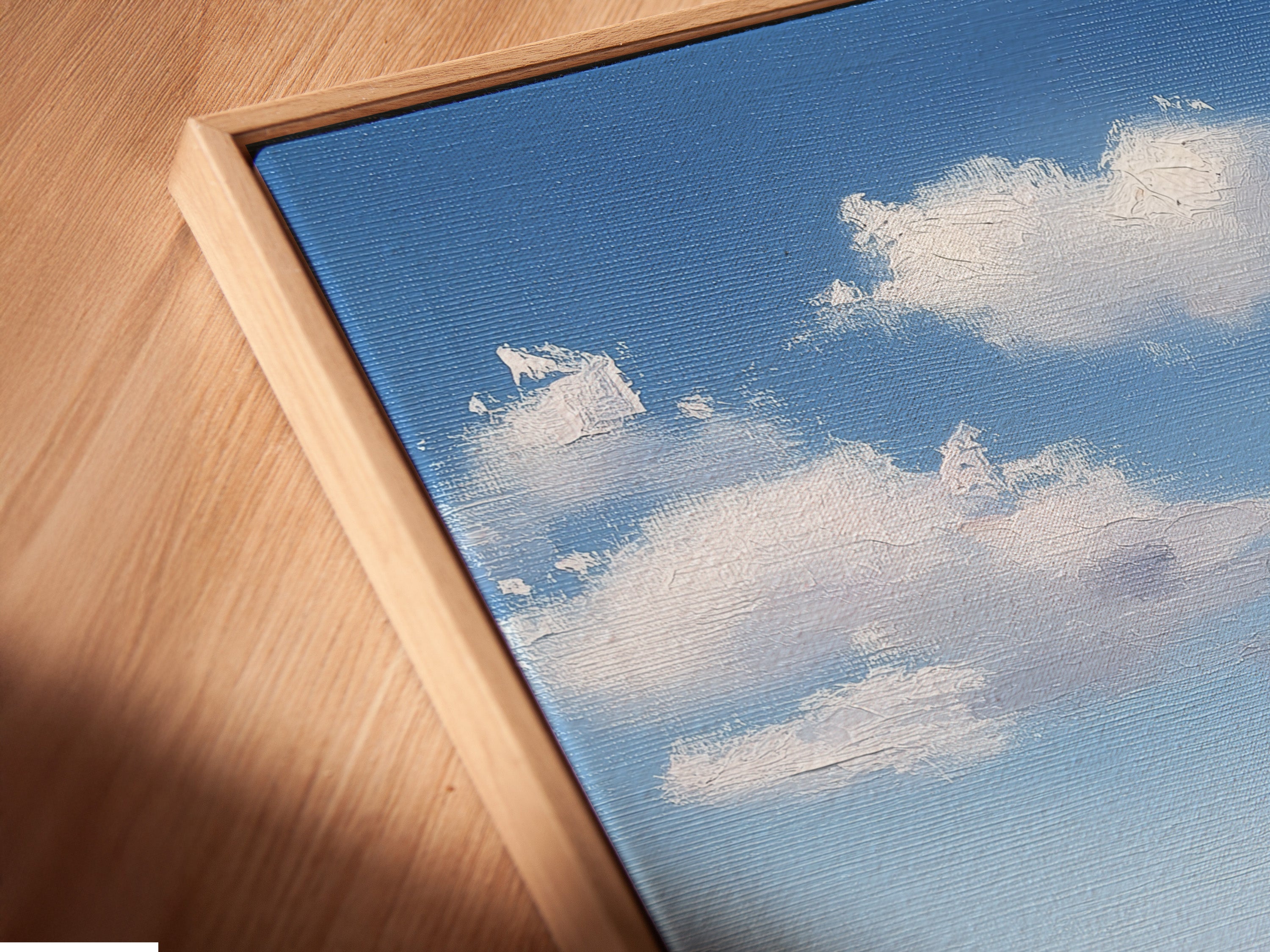 Angled close-up of a canvas print. The print is displayed in a floating frame. The floating frame gives the illusion of the artwork floating. It adds depth and dimension to the piece. It creates a modern look.