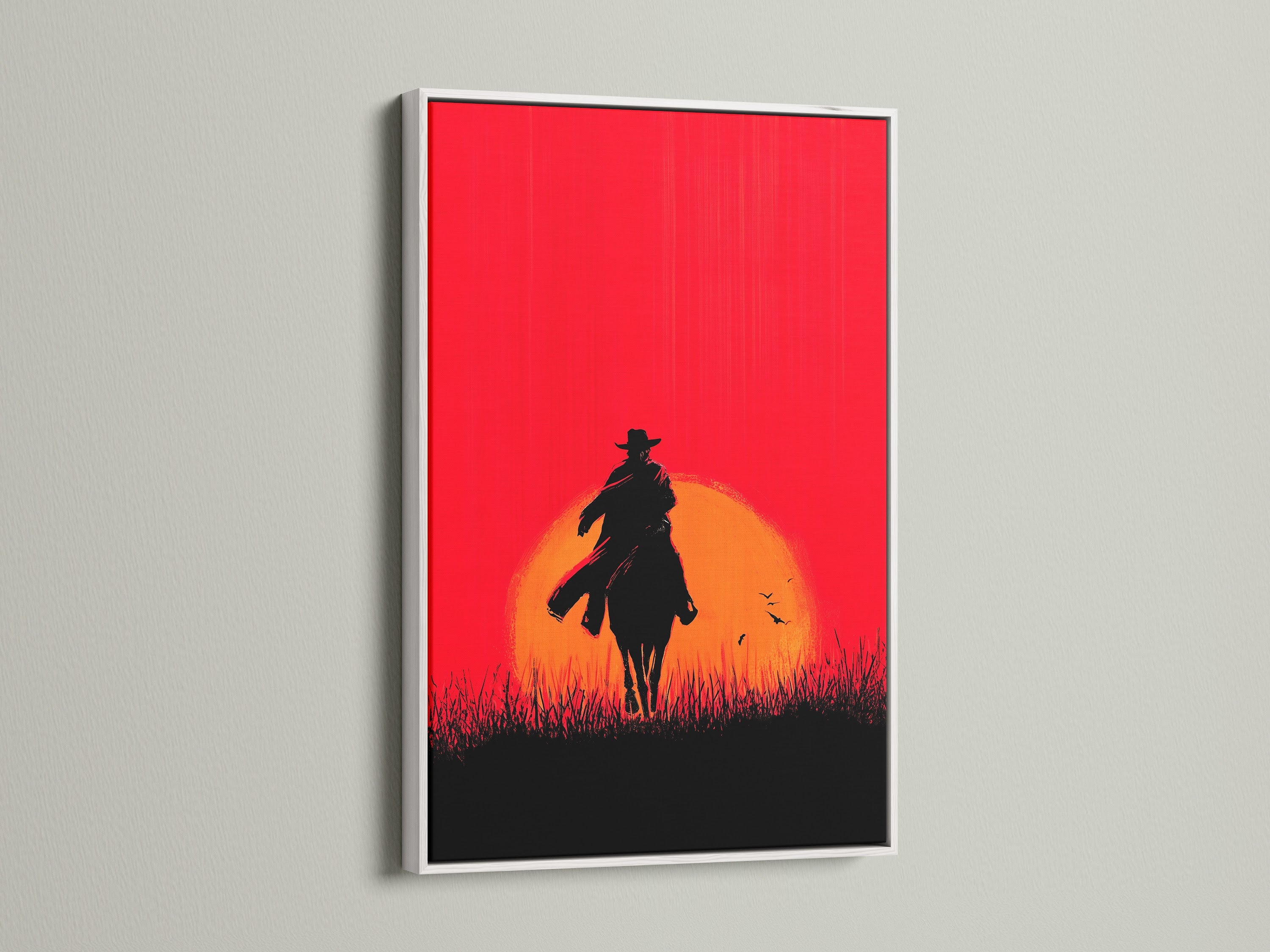 Cowboy Sunset Canvas Print with white frame. This artwork brings a touch of the Wild West to any room. The red orange sunset silhouette creates a striking visual impact. Enhance your western artwork collection today with this cowboy poster.