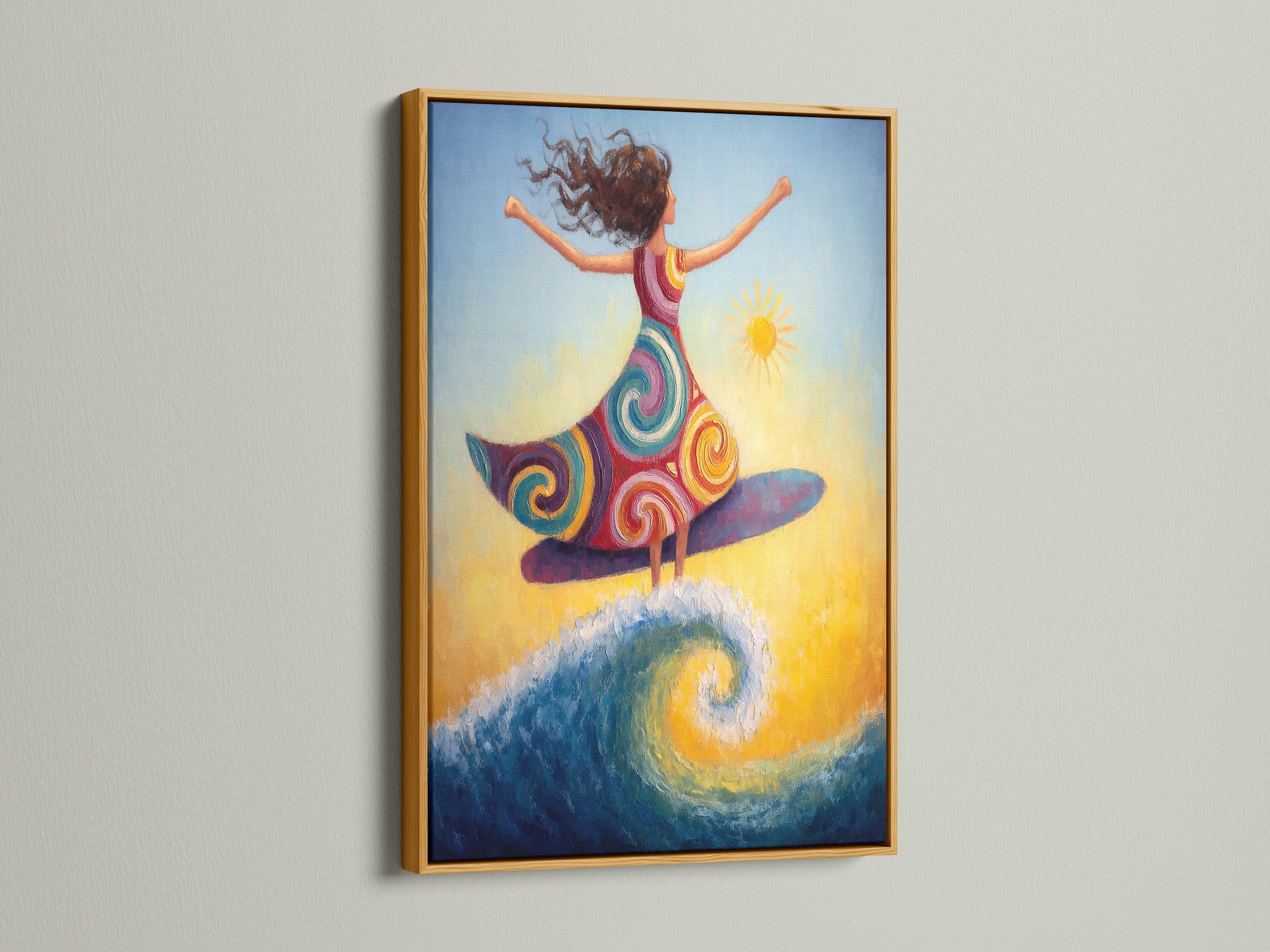 A surfing girl canvas artwork is framed in gold. The gold frame adds a touch of elegance to this bohemian artwork. This colorful artwork is perfect for coastal decor. Consider this sunny art print for interior designers and stagers.